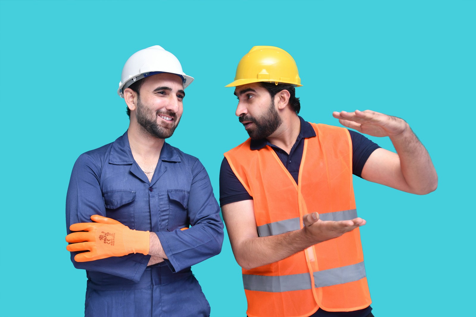 a couple of men wearing hard hats